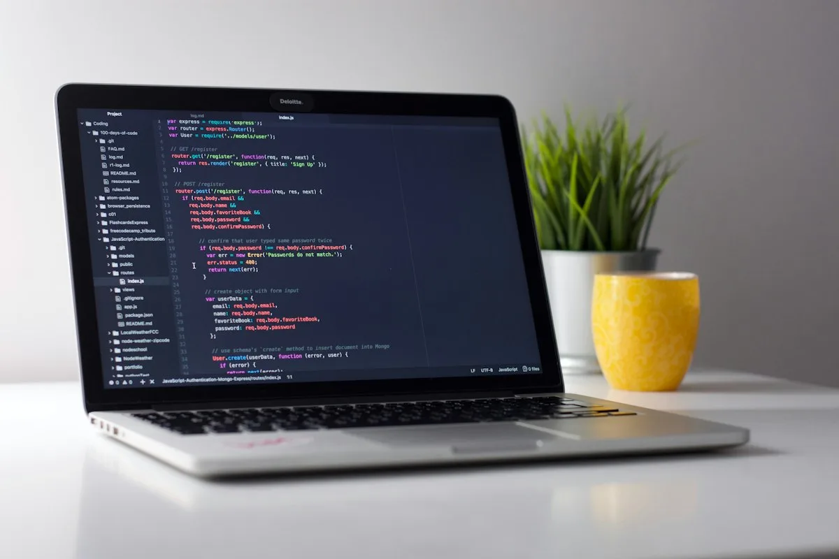 Developer coding on laptop with clean workspace